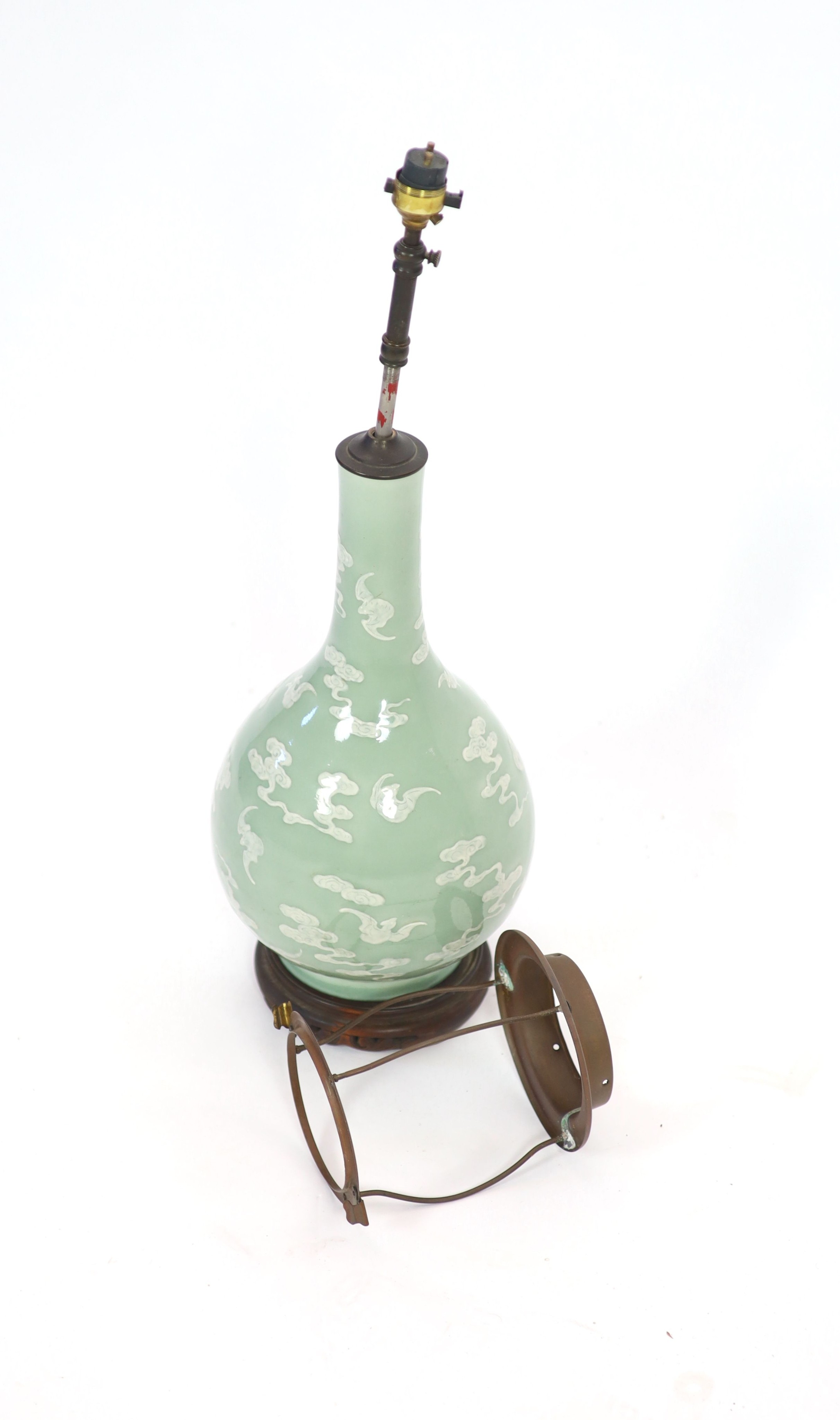 A Chinese celadon-glazed slip-decorated bottle vase, Qianlong seal mark and period (1736-95), Formerly mounted as a lamp with drilled hole through the seal mark and base.